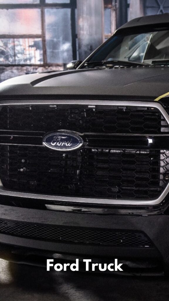 photo of the grille of a ford truck sitting in a new car showroom