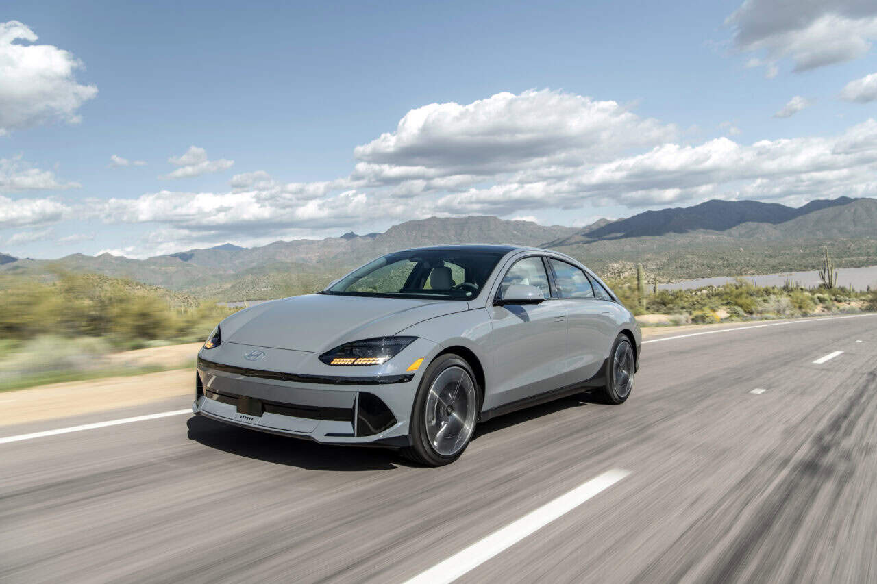 photo of a Hyundai Ioniq 6 driving down a desert highway.