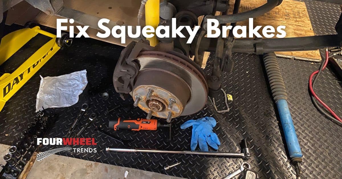 photo of a Jeep Wrangler with the tire off getting new brakes and shocks installed while on a floor jack